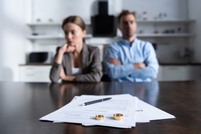 Selective,Focus,Of,Couple,Sitting,At,Table,With,Divorce,Documents